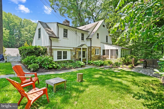 6620 Charlesway, Towson, MD 21204 - rear view of house featuring stone siding, a chimney, and a sunroom