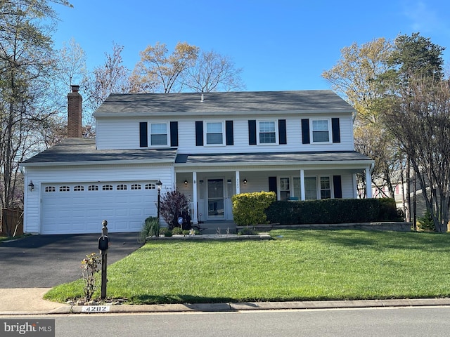 4282 Berwick Pl, Woodbridge, VA 22192 - traditional-style home with asphalt driveway, a front yard, a garage, a porch, and a chimney