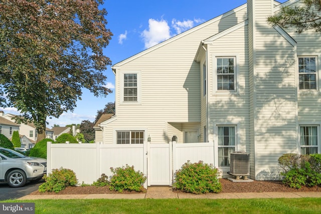 26 Portsmouth Ct, Holland, PA 18966 - view of property exterior with a central AC unit and a chimney