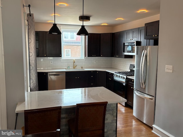 643 Jamestown Ave, Philadelphia, PA 19128 - kitchen with appliances with stainless steel finishes, backsplash, light wood-type flooring, light stone counters, and recessed lighting