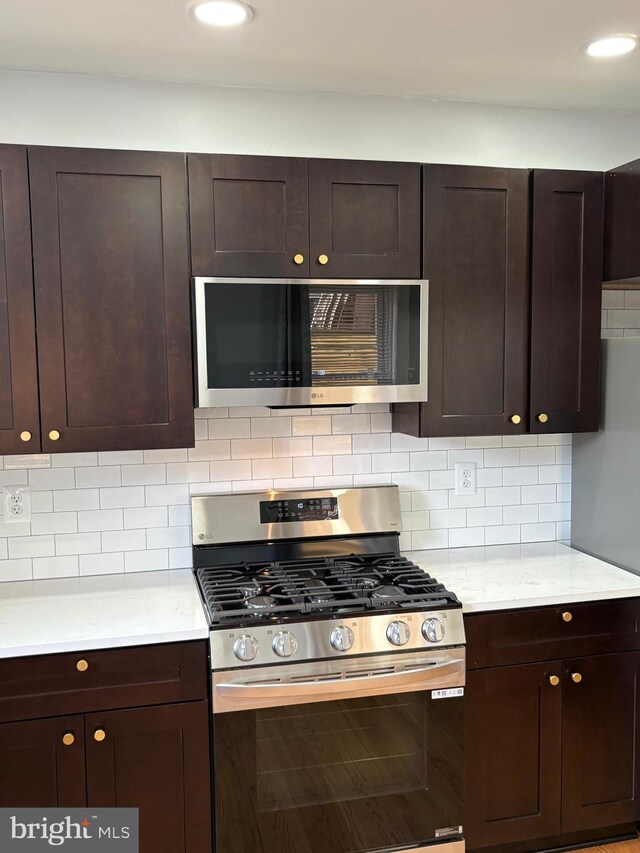 643 Jamestown Ave, Philadelphia, PA 19128 - kitchen featuring stainless steel gas stove, dark brown cabinets, backsplash, and recessed lighting