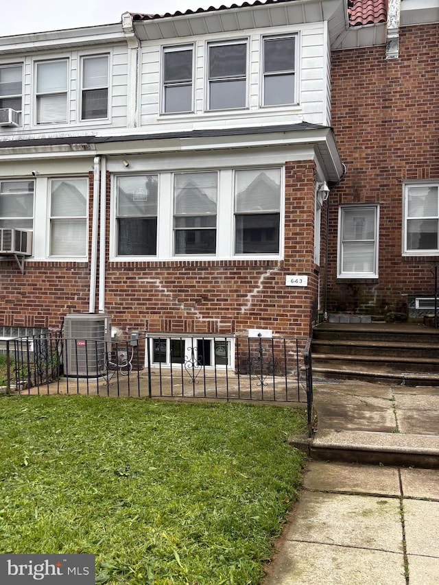 643 Jamestown Ave, Philadelphia, PA 19128 - view of front of home featuring a fenced front yard, cooling unit, and brick siding