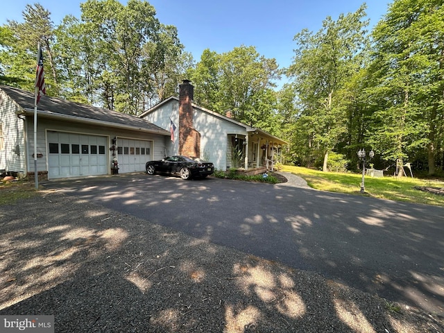 13 Mark Ln, Tabernacle, NJ 08088 - view of property exterior with asphalt driveway, an attached garage, and a chimney