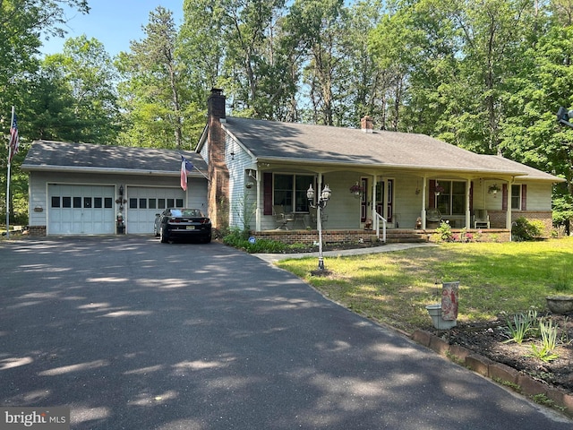 13 Mark Ln, Tabernacle, NJ 08088 - view of front of house featuring asphalt driveway, an attached garage, covered porch, a chimney, and a front lawn