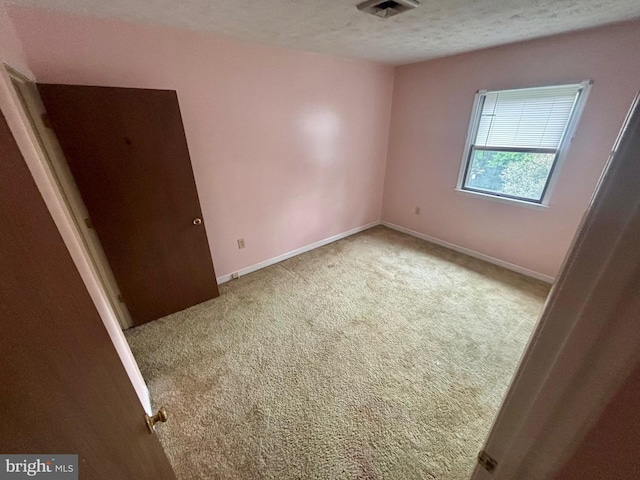 311 Ash Hollow Dr, Winchester, VA 22602 - carpeted spare room with a textured ceiling and baseboards