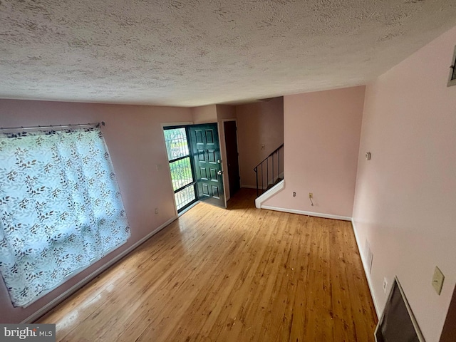 311 Ash Hollow Dr, Winchester, VA 22602 - empty room featuring wood finished floors, a textured ceiling, and stairway