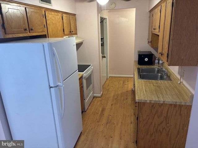 311 Ash Hollow Dr, Winchester, VA 22602 - kitchen featuring white appliances, light wood-type flooring, exhaust hood, brown cabinetry, and light countertops