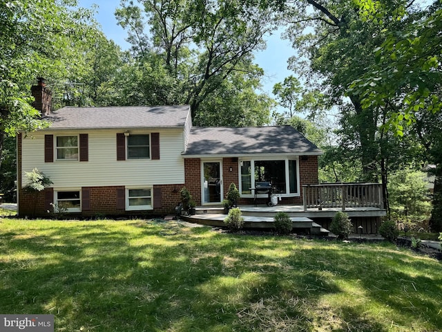643 Crestwood Rd, Wayne, PA 19087 - split level home featuring a chimney, a front lawn, a wooden deck, and brick siding