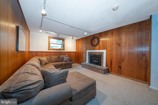 643 Crestwood Rd, Wayne, PA 19087 - living room with wooden walls, carpet flooring, rail lighting, and a brick fireplace