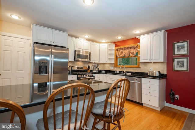 643 Crestwood Rd, Wayne, PA 19087 - kitchen featuring appliances with stainless steel finishes, dark countertops, white cabinetry, and recessed lighting