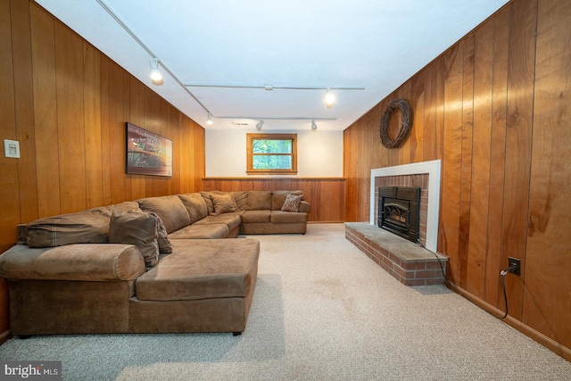 643 Crestwood Rd, Wayne, PA 19087 - carpeted living area with wood walls, rail lighting, and a brick fireplace