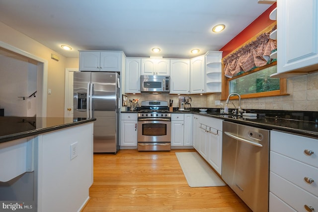643 Crestwood Rd, Wayne, PA 19087 - kitchen featuring appliances with stainless steel finishes, dark countertops, light wood-style floors, backsplash, and recessed lighting