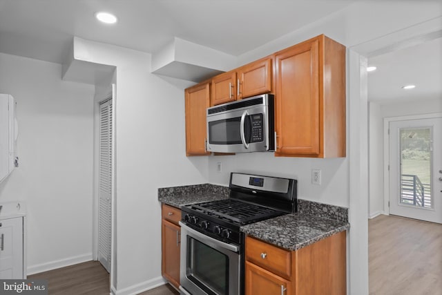 618 Cabin Branch Dr, Capitol Heights, MD 20743 - kitchen with stainless steel appliances, dark wood-type flooring, dark stone counters, and recessed lighting