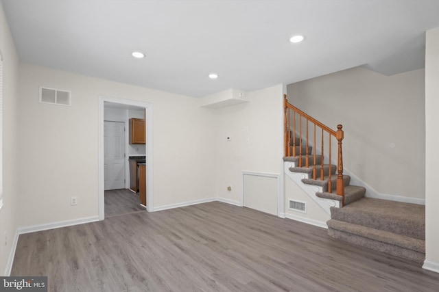 618 Cabin Branch Dr, Capitol Heights, MD 20743 - unfurnished living room with wood finished floors, stairs, and recessed lighting