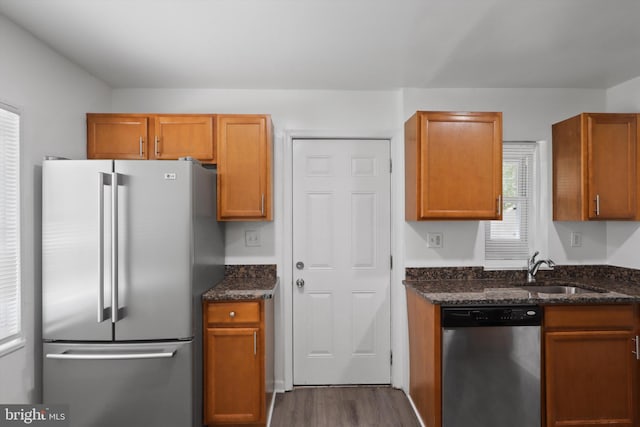 618 Cabin Branch Dr, Capitol Heights, MD 20743 - kitchen with appliances with stainless steel finishes, dark stone countertops, dark wood-type flooring, and brown cabinetry