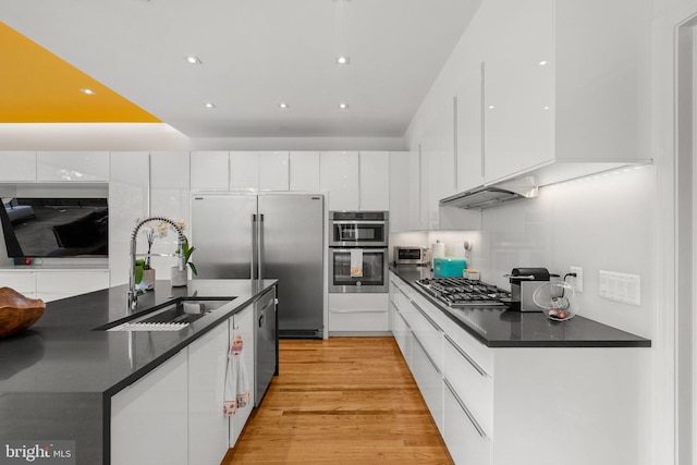 2815 39th St NW, Washington, DC 20007 - kitchen featuring dark countertops, appliances with stainless steel finishes, white cabinetry, and recessed lighting
