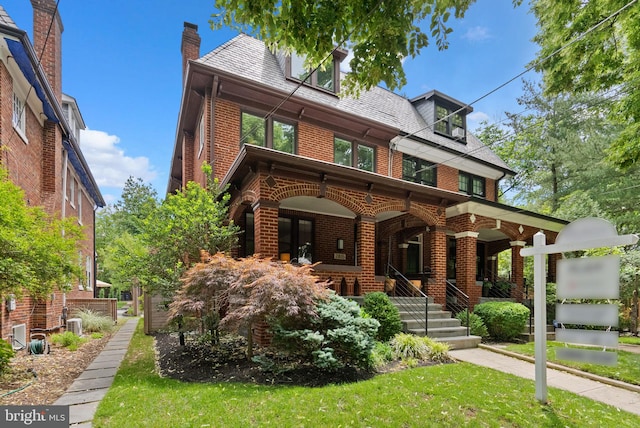 2815 39th St NW, Washington, DC 20007 - view of front facade featuring brick siding, a high end roof, a porch, a front lawn, and a chimney