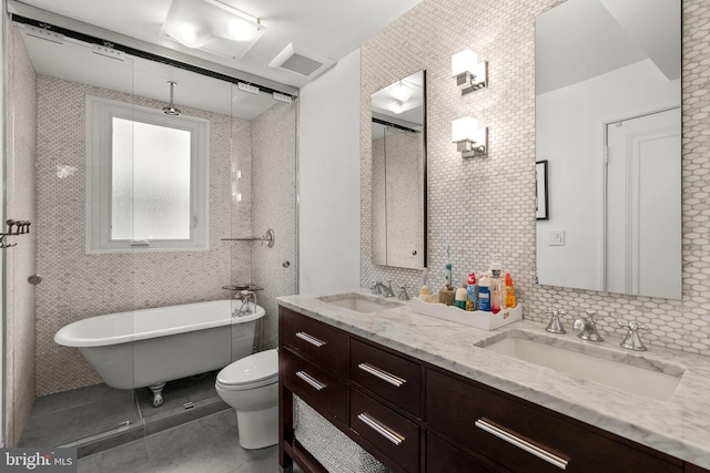 2815 39th St NW, Washington, DC 20007 - bathroom featuring tile patterned floors, a freestanding tub, double vanity, and tasteful backsplash