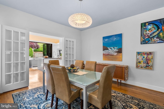 2815 39th St NW, Washington, DC 20007 - dining area featuring wood finished floors, a chandelier, and french doors