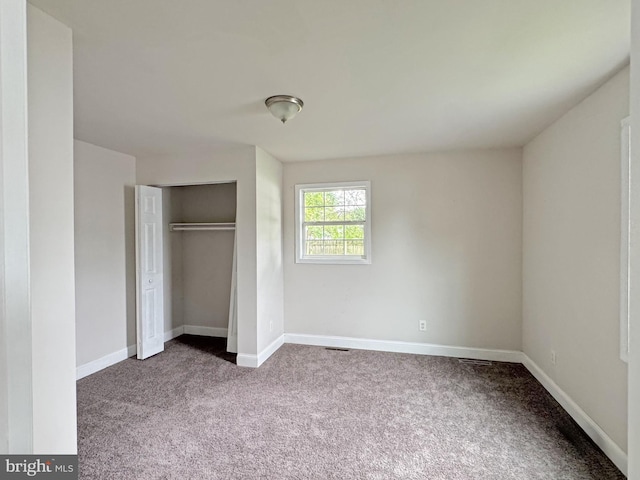 112 Dorman St, Harrington, DE 19952 - unfurnished bedroom with dark carpet and a closet
