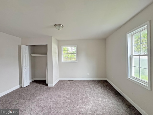 112 Dorman St, Harrington, DE 19952 - unfurnished bedroom with dark carpet and a closet