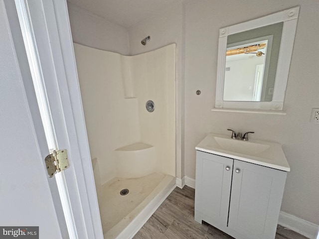 112 Dorman St, Harrington, DE 19952 - full bath with a walk in shower, vanity, and wood finished floors