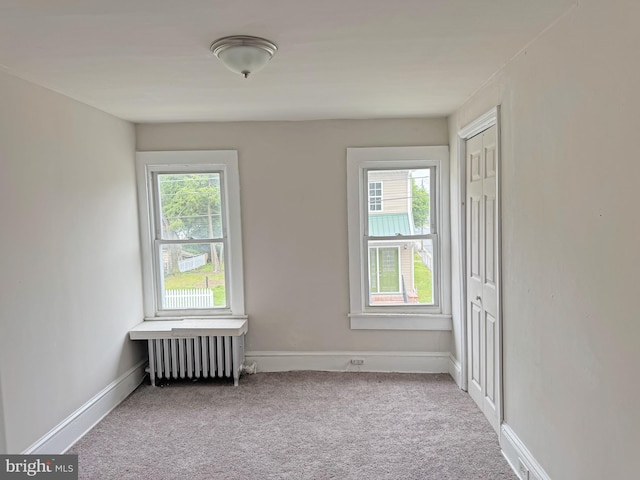 112 Dorman St, Harrington, DE 19952 - carpeted spare room featuring radiator heating unit and plenty of natural light