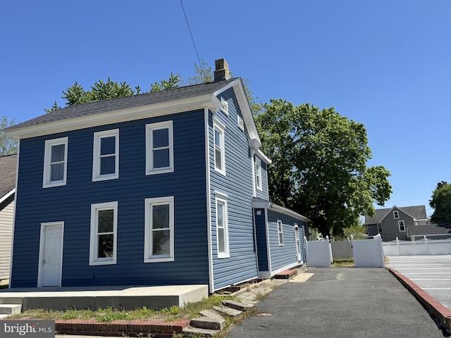 112 Dorman St, Harrington, DE 19952 - view of side of property featuring a chimney and a central air condition unit