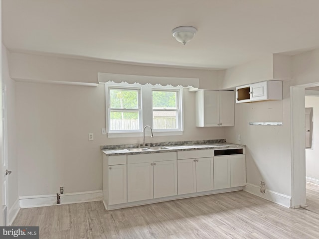 112 Dorman St, Harrington, DE 19952 - kitchen featuring light wood finished floors and white cabinets