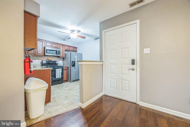 1043 Tristram Cir, Mantua, NJ 08051 - kitchen featuring appliances with stainless steel finishes, wood-type flooring, ceiling fan, and brown cabinetry