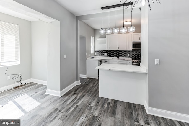 4219 Granada Ave, Baltimore, MD 21215 - kitchen featuring appliances with stainless steel finishes, white cabinetry, backsplash, open shelves, and dark wood-style flooring
