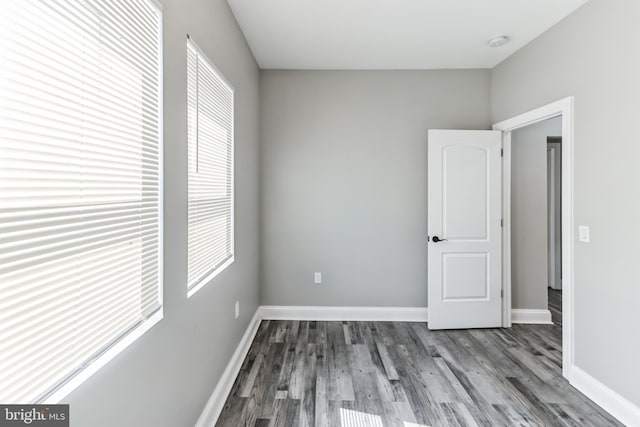 4219 Granada Ave, Baltimore, MD 21215 - unfurnished bedroom with multiple windows and wood finished floors