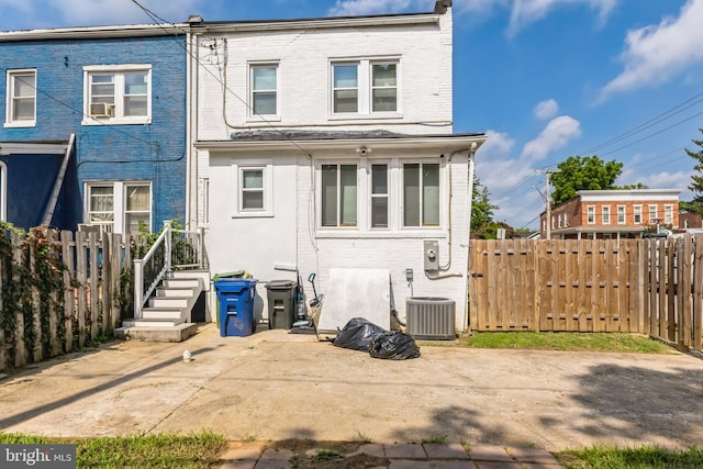 4219 Granada Ave, Baltimore, MD 21215 - rear view of property featuring brick siding, a patio, and cooling unit