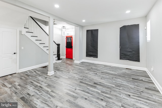 4219 Granada Ave, Baltimore, MD 21215 - unfurnished living room featuring stairway, wood finished floors, and recessed lighting