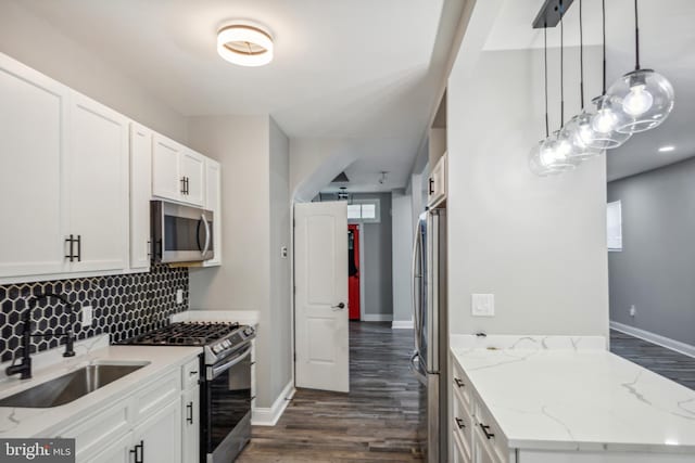 4219 Granada Ave, Baltimore, MD 21215 - kitchen with stainless steel appliances, dark wood-type flooring, backsplash, light stone countertops, and white cabinets