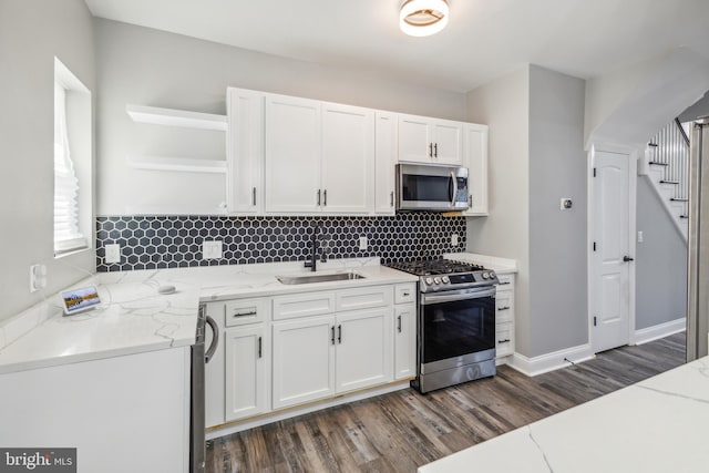 4219 Granada Ave, Baltimore, MD 21215 - kitchen featuring appliances with stainless steel finishes, open shelves, white cabinetry, dark wood-style floors, and decorative backsplash