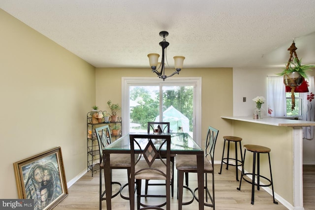 12518 Tove Rd, Clinton, MD 20735 - dining room featuring a textured ceiling, light wood-style flooring, and a chandelier