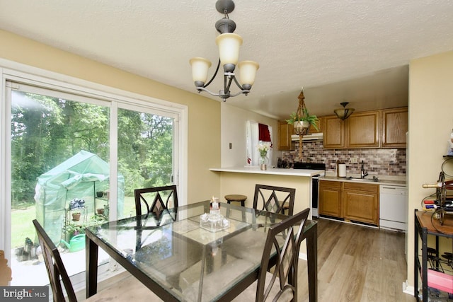 12518 Tove Rd, Clinton, MD 20735 - dining area featuring a chandelier, wood finished floors, and a textured ceiling
