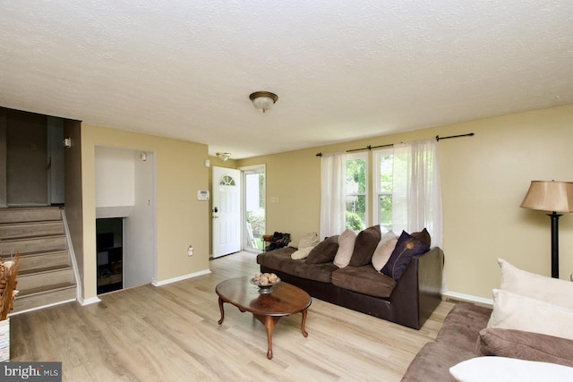 12518 Tove Rd, Clinton, MD 20735 - living area featuring wood finished floors, stairway, and a textured ceiling