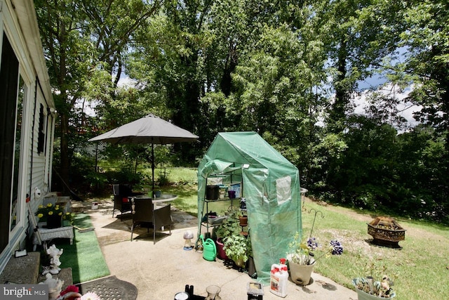12518 Tove Rd, Clinton, MD 20735 - view of patio with a fire pit and view of scattered trees
