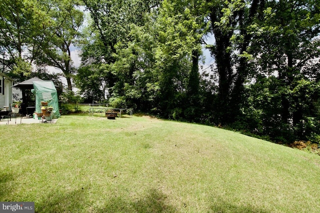 12518 Tove Rd, Clinton, MD 20735 - view of grassy yard with a fire pit