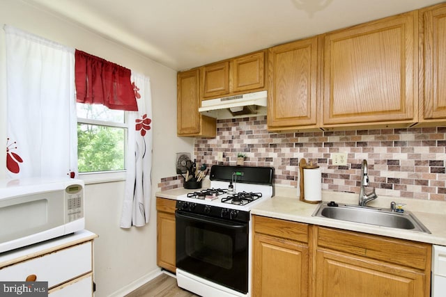 12518 Tove Rd, Clinton, MD 20735 - kitchen featuring range with gas stovetop, under cabinet range hood, white microwave, and light countertops