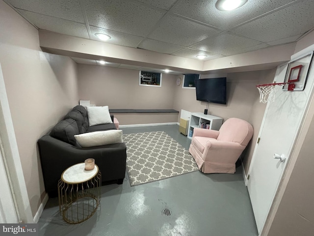 7301 Granite Rd, Elkins Park, PA 19027 - living area with concrete flooring and a paneled ceiling