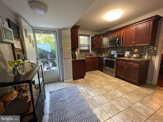 7301 Granite Rd, Elkins Park, PA 19027 - kitchen featuring appliances with stainless steel finishes, backsplash, light tile patterned flooring, and light countertops
