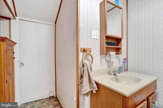 2605 N Sherman St, York, PA 17406 - bathroom featuring wallpapered walls, vanity, and a textured ceiling