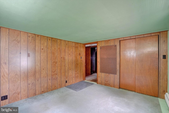 2605 N Sherman St, York, PA 17406 - unfurnished bedroom featuring wooden walls and a baseboard radiator