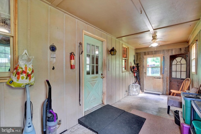 2605 N Sherman St, York, PA 17406 - foyer featuring wood walls, a ceiling fan, unfinished concrete floors, and crown molding
