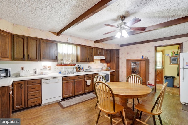 2605 N Sherman St, York, PA 17406 - kitchen with white appliances, a textured ceiling, beamed ceiling, light wood-style floors, and under cabinet range hood