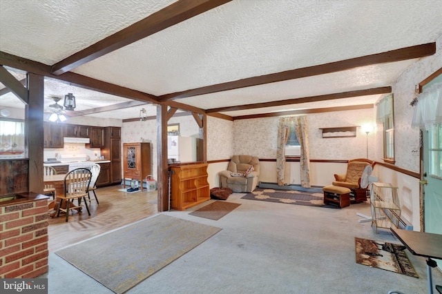 2605 N Sherman St, York, PA 17406 - living room featuring a textured ceiling, beam ceiling, wallpapered walls, ceiling fan, and light colored carpet