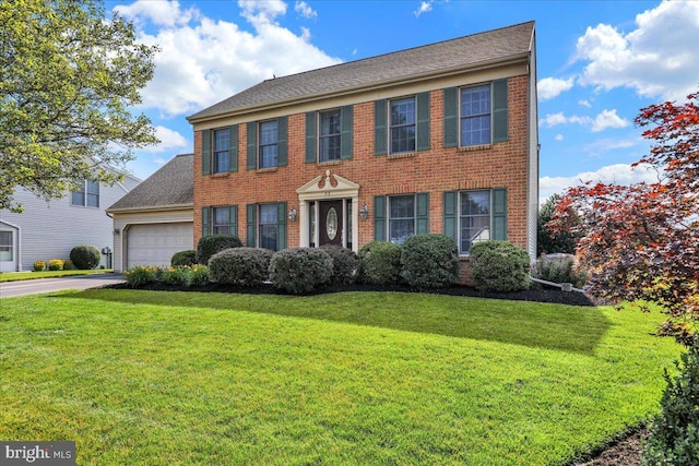 32 Duffield Dr, Lititz, PA 17543 - view of front of home featuring a garage, a front yard, asphalt driveway, and brick siding